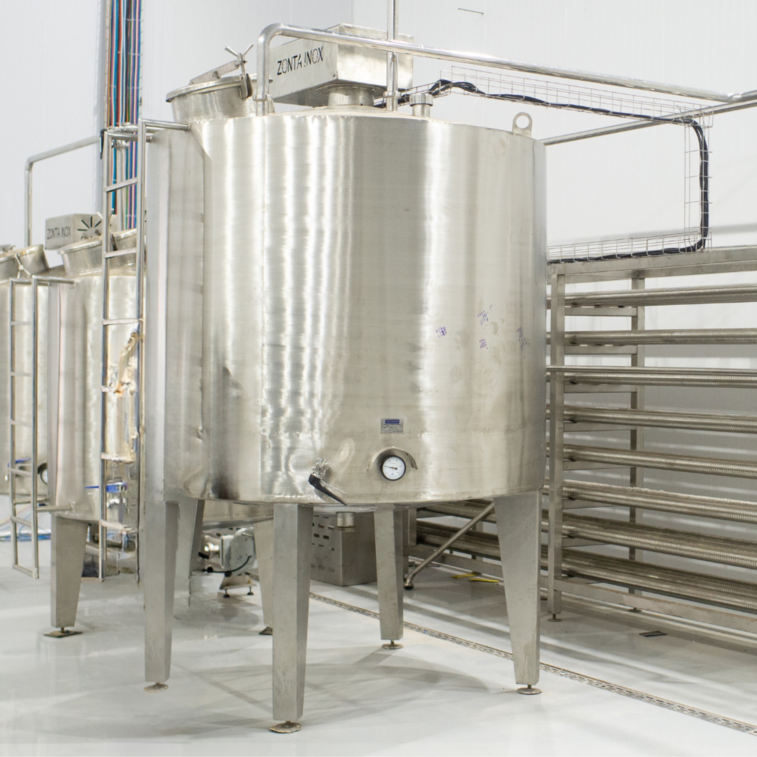 Stainless steel fermentation tanks in a clean room setting - Prime Green Trade
